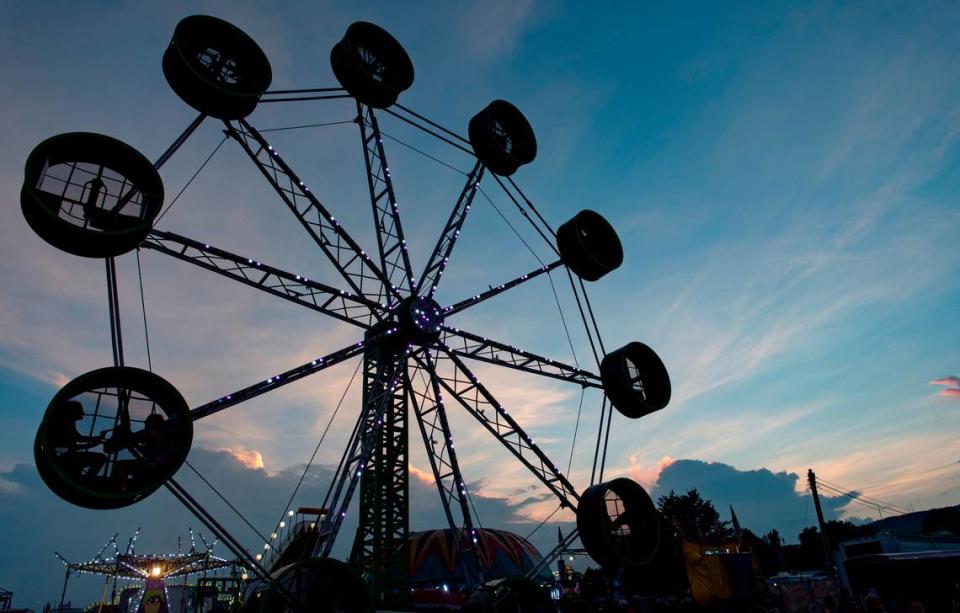 The sun sets over the Bartlebaugh Amusements rides at the Centre County Grange Fair on Thursday, Aug. 26, 2021.