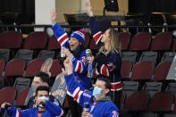 Fans of the New York Rangers celebrate in the third period of an NHL hockey game against the New Jersey Devils, Thursday, March 4, 2021, in Newark, N.J. The Rangers defeated the Devils 6-1. (AP Photo/Kathy Willens)