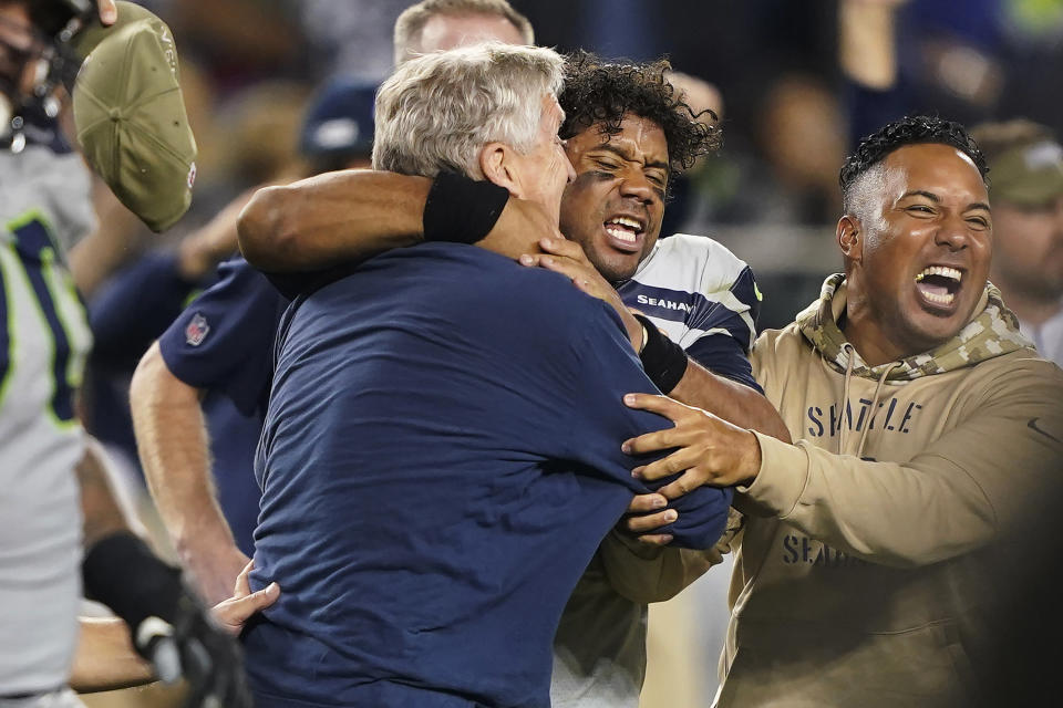 Seattle Seahawks head coach Pete Carroll, left, celebrates with quarterback Russell Wilson, center, after the Seahawks defeated the San Francisco 49ers 27-24 in overtime of an NFL football game in Santa Clara, Calif., Monday, Nov. 11, 2019. (AP Photo/Tony Avelar)