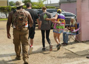 A patient is escorted into the Jackson Women's Health Organization clinic compound by security officers and clinic escorts, in Jackson, Miss., Tuesday, June 28, 2022. The clinic is the only facility that performs abortions in the state. (AP Photo/Rogelio V. Solis)