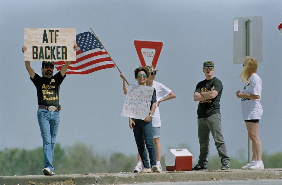 Four people demonstrate in favor of the Bureau of Alcohol, Tobacco and Firearms agents near the Branch Davidian compound outside Waco, Texas, March 27, 1993. The ATF has been criticized for its failed attempt to serve a search warrant on the cult compound on Feb. 28. Four agents were killed and the standoff enters its fifth week Sunday.