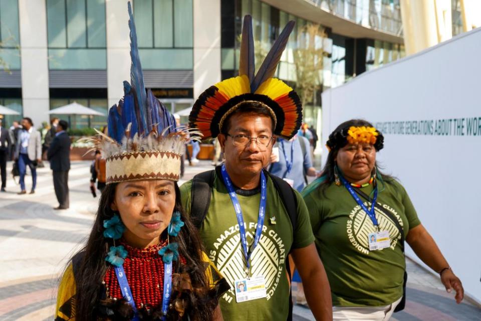 Participants in traditional outfits at COP28