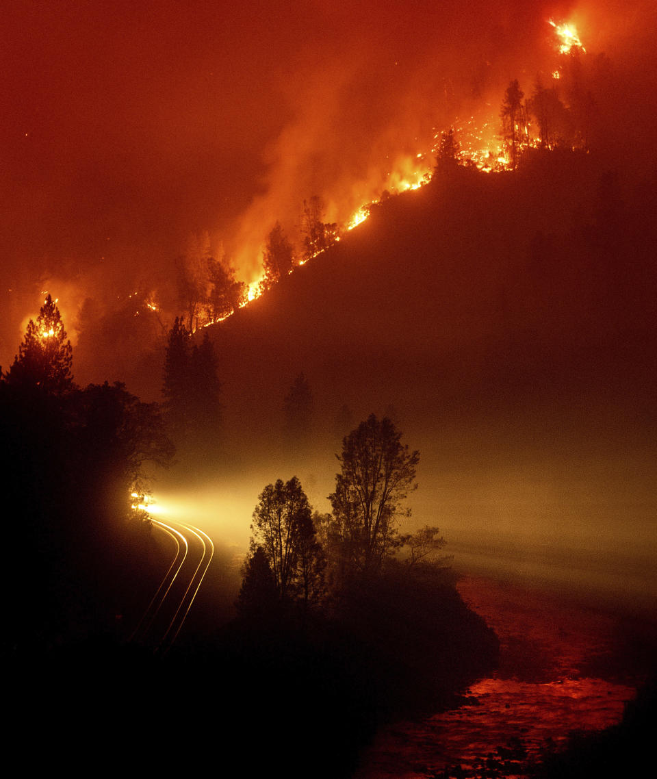 The Delta Fire burns in the Shasta-Trinity National Forest, Calif., on Thursday, Sept. 6, 2018. The wildfire closed both directions of Interstate 5 leaving trucks parked on the shoulder for more than two miles waiting to pass through. (AP Photo/Noah Berger)