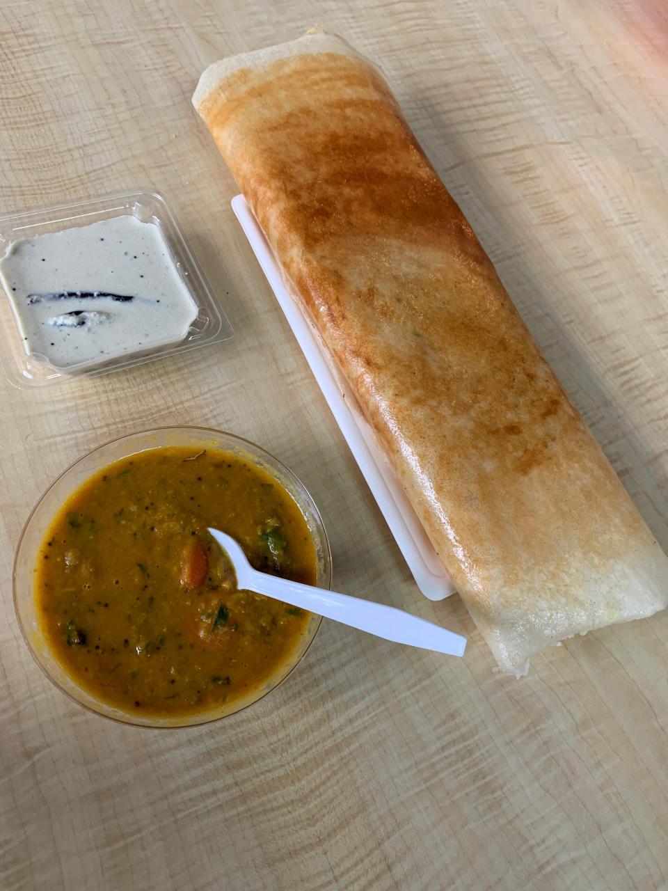 Masala dosa is an Indian crepe filled with potatoes and served with lentil soup and coconut chutney at Heera Indian Cuisine in downtown Akron.