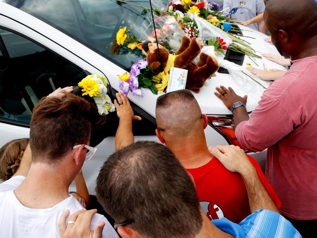 The victims’ cars, left in a nearby parking lot ahead of the tour, were adorned with flowers, stuffed animals, balloons and handwritten notes expressing condolences: AP