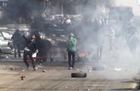 Supporters and opponents of ousted Egyptian President Mohamed Mursi clash at Nasr City district in Cairo, January 3, 2014. (REUTERS/Mohamed Abd El Ghany)