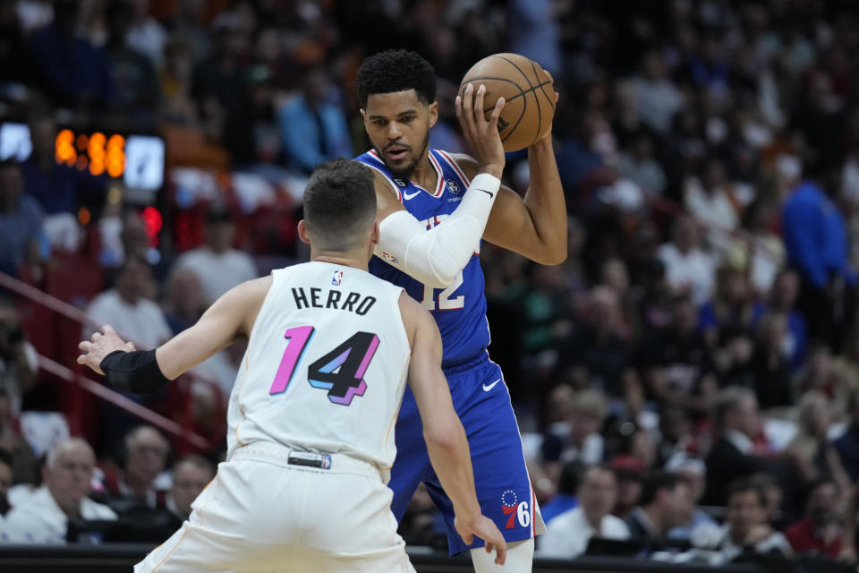 Philadelphia 76ers forward Tobias Harris (12) looks for an opening past Miami Heat guard Tyler Herro (14) during the first half of an NBA basketball game, Wednesday, March 1, 2023, in Miami. (AP Photo/Wilfredo Lee)