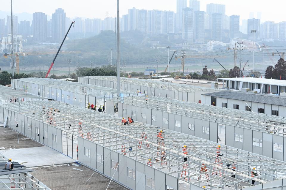 This photo taken on November 22, 2022 shows employees working at a makeshift hospital that will be used for Covid-19 coronavirus patients in China's southwestern city of Chongqing.