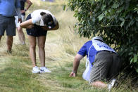 In Gee Chun, of South Korea, left, looks for her ball in the rough on the 16th hole during the third round in the Women's PGA Championship golf tournament at Congressional Country Club, Saturday, June 25, 2022, in Bethesda, Md. (AP Photo/Nick Wass)