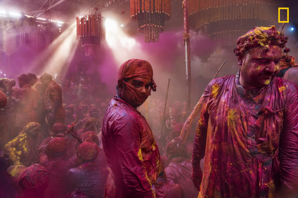 <p>Lath mar Holi is a local celebration of the Hindu festival of Holi. It takes place days before the actual Holi in the neighboring towns of Barsana and Nandgaon near Mathura in the state of Uttar Pradesh, where thousands of Hindus and tourists congregate, each year. (© Sampa Guha Majumdar/National Geographic Travel Photographer of the Year Contest) </p>