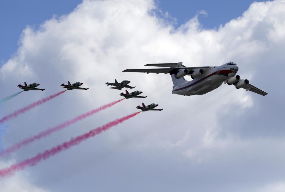 Belarus' IL-76 MD transport aircraft, right, and army jet fighters fly over the city during the Victory Day military parade that marked the 75th anniversary of the allied victory over Nazi Germany, in Minsk, Belarus, Saturday, May 9, 2020. Belarus remains one of the few countries that hadn't imposed a lockdown or restricted public events despite recommendations of the World Health Organization. (AP Photo/Sergei Grits)