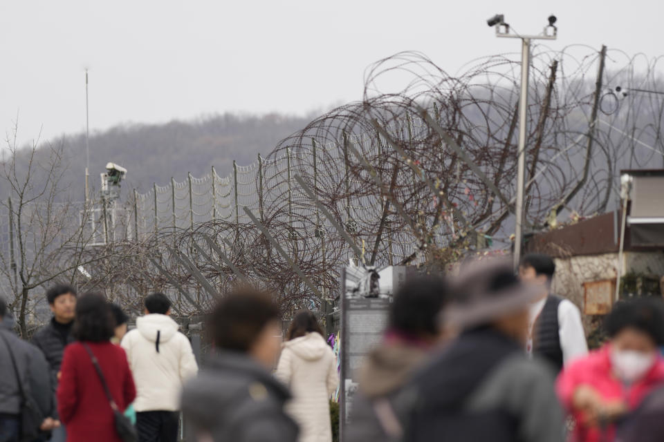 Visitors tour near the military wire fence at the Imjingak Pavilion in Paju, South Korea, Wednesday, Nov. 22, 2023. South Korea will partially suspend an inter-Korean agreement Wednesday to restart frontline aerial surveillance of North Korea, after the North said it launched a military spy satellite in violation of United Nations bans, Seoul officials said. (AP Photo/Lee Jin-man)