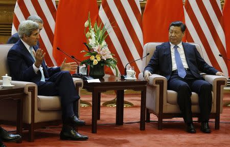 U.S. Secretary of State John Kerry talks with China's President Xi Jinping (R) during a meeting at the Great Hall of the People in Beijing July 10, 2014. REUTERS/Jim Bourg