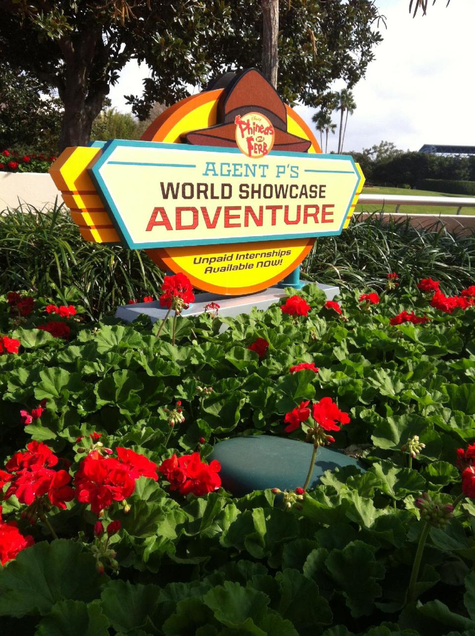 In this Feb. 13, 2013 photo, a sign encouraging Walt Disney World guests to participate in the "Agent P's World Showcase Adventure" game is displayed at the Epcot theme park in Lake Buena Vista, Fla. The "Agent P" game and others like it represent a recent push by Disney World to provide its guests with attractions that allow them to interact with their favorite characters. (AP Photo/Mike Householder)