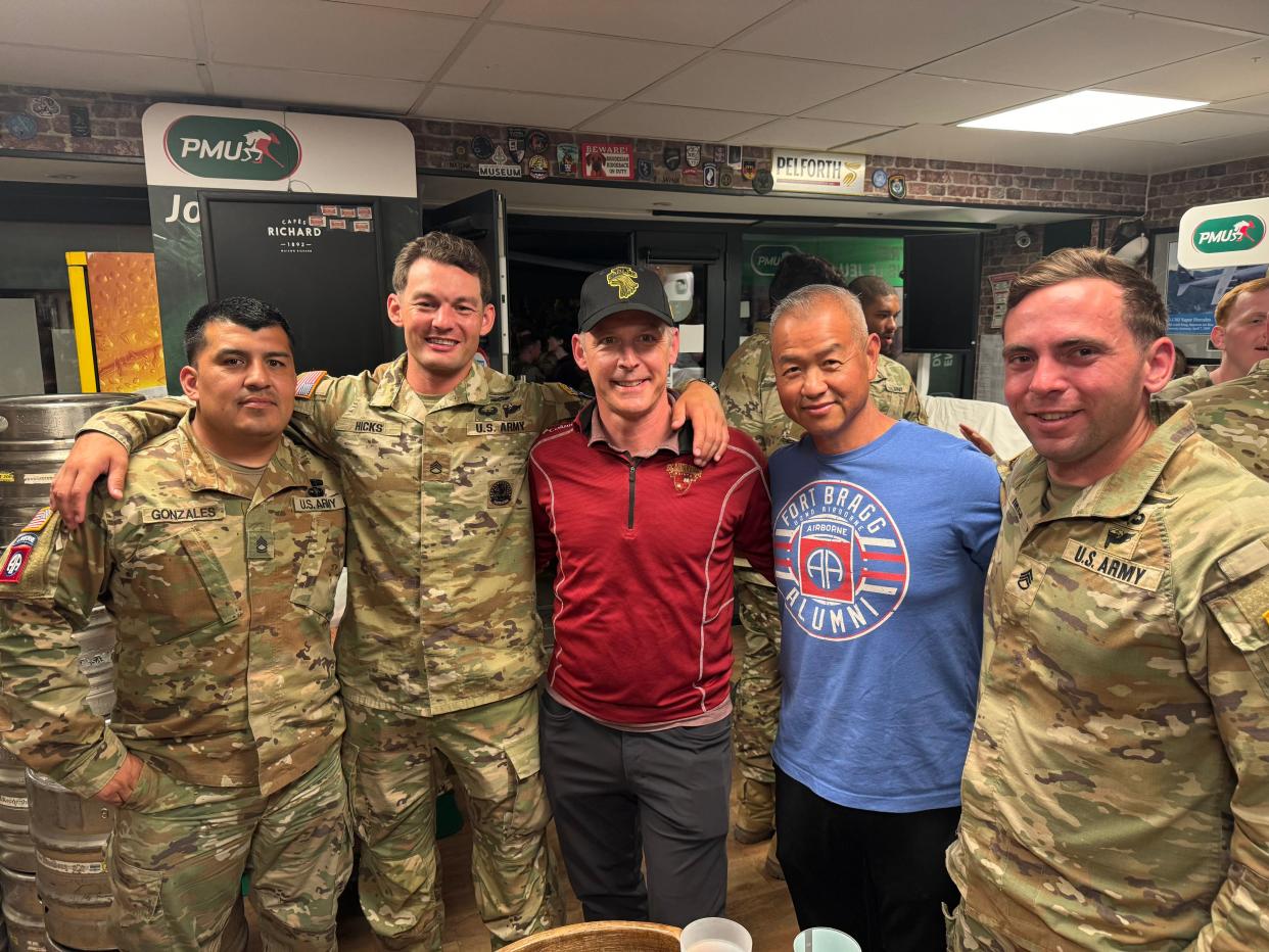 U.S. Army veterans and Jupiter residents Chung Wong and William Paczkowski smile alongside active members of the U.S. Army in Normandy, France, on June 3, 2024.