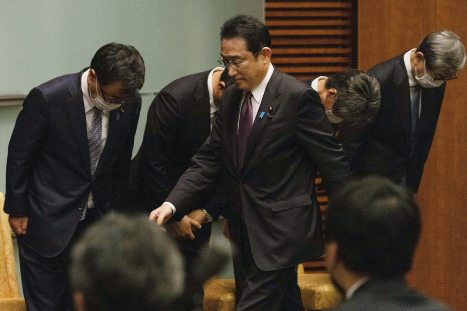 Japanese Prime Minister Fumio Kishida arrives at a news conference in Tokyo, Wednesday, March 16, 2022. Kishida on Wednesday announced plans to fully lift coronavirus restrictions on March 21 as new infections driven by the highly contagious omicron variant slow. (Stanislav Kogiku/Pool Photo via AP)