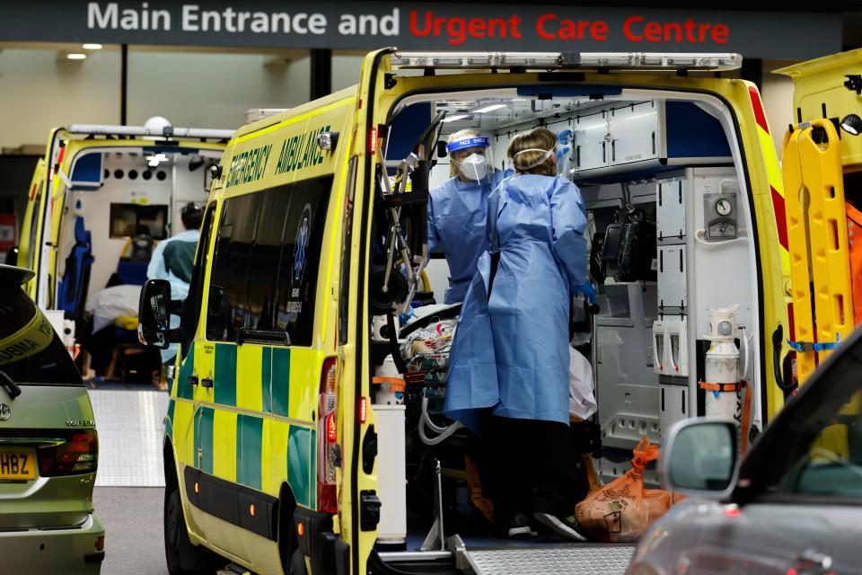 Paramedics prepare to remove a patient from an ambulance parked outside Guy's Hospital in London on December 29, 2020, as a new strain of the coronavirus appears to be behind the recent upsurge in cases, heaping further pressure on the state-run National Health Service during its busiest winter period. - England is "back in the eye" of the coronavirus storm, health chiefs warned, with as many patients in hospital as during the initial peak in April. (Photo by Tolga Akmen / AFP) (Photo by TOLGA AKMEN/AFP via Getty Images)