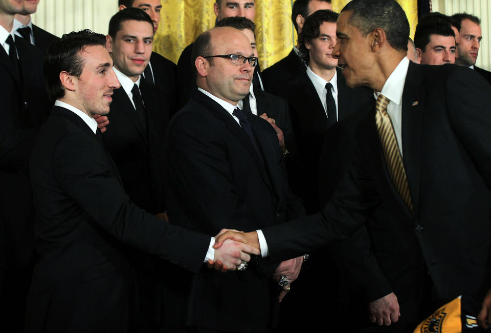 WASHINGTON, DC - JANUARY 23: U.S. President Barack Obama (R) shakes hands with hockey player Brad Marchand (L) of the Boston Bruins as team general manager Peter Chiarelli (2nd L) looks on during a East Room event at the White House January 23, 2012 in Washington, DC. The six-time Stanley Cup champions were honored by the President for winning the 2011 Stanley Cup last June. (Photo by Alex Wong/Getty Images)