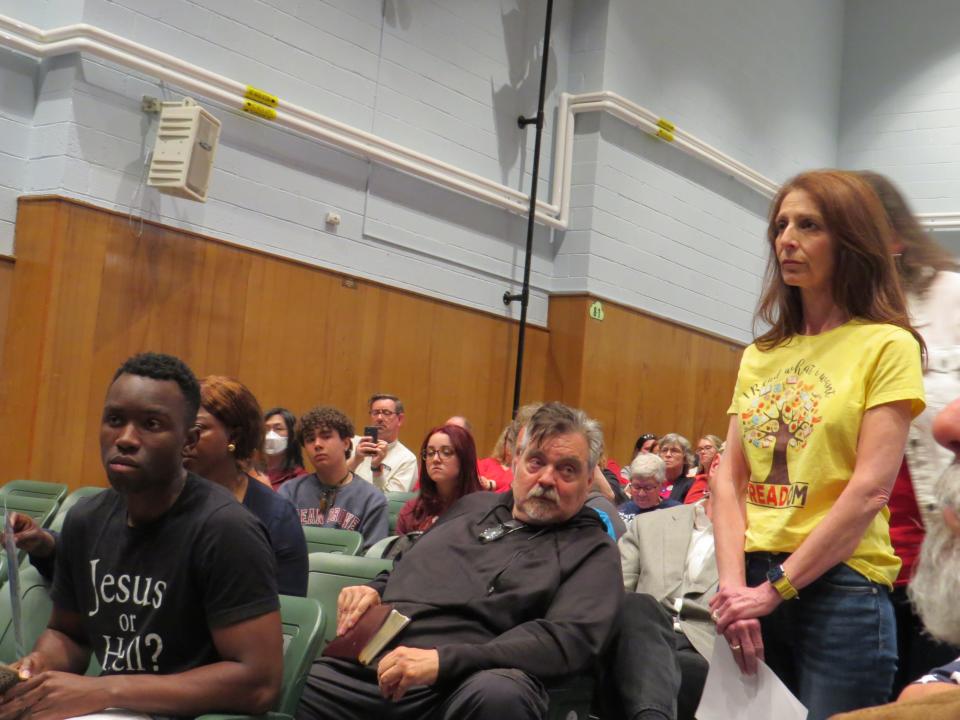 Roxbury High School librarian Roxana Russo Caivano, standing, waits to speak. Heated voices on both sides of the debate over state-mandated books addressing LGBTQ topics were heard during a marathon Roxbury Board of Education meeting.
