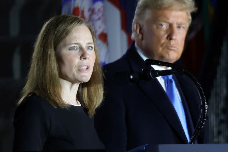 FILE PHOTO: U.S. President Trump looks on as Judge Barrett delivers remarks after she was sworn in as an associate justice of the U.S. Supreme Court at the White House in Washington