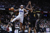 Orlando Magic forward Paolo Banchero (5) passes against Cleveland Cavaliers forward Evan Mobley (4) during the second half of Game 5 of an NBA basketball first-round playoff series, Tuesday, April 30, 2024, in Cleveland. (AP Photo/Ron Schwane)