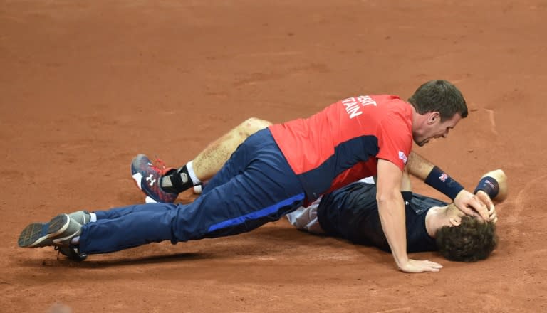 Britain's Davis Cup captain Leon Smith celebrates with Andy Murray after beating Belgium to win the tournament on November 29, 2015