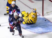 United States' Alex Turcotte (15) and Trevor Zegras (9) celebrate a goal as Sweden goalie Hugo Alnefelt (30) sits on the ice during the second period of an IIHF World Junior Hockey Championship game Thursday, Dec. 31, 2020, in Edmonton, Alberta. (Jason Franson/The Canadian Press via AP)