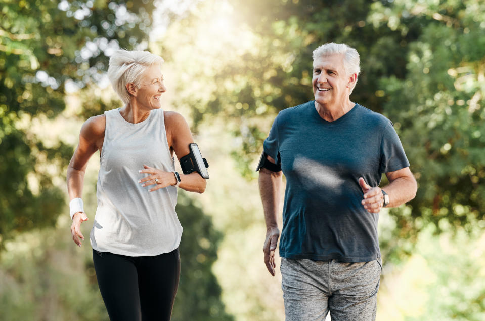 Health, senior couple, hiking in nature or park, exercise, fitness, welcome. Happy elderly couple enjoys a walk in the forest, fresh air, conversation, training, training and relaxing on holiday.