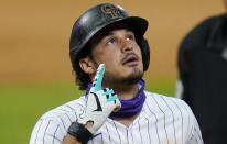 Colorado Rockies' Nolan Arenado points to the sky after hitting a solo home run against the San Francisco Giants during the sixth inning of a baseball game Tuesday, Aug. 4, 2020, in Denver. (AP Photo/Jack Dempsey)