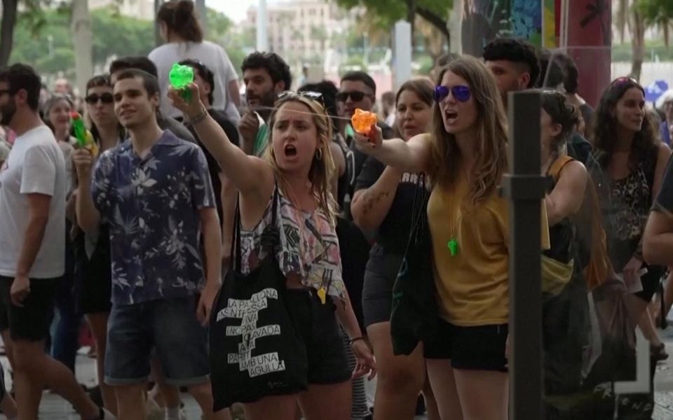 Anti-tourism protesters spray tourists with water pistols in Barcelona, ​​Spain