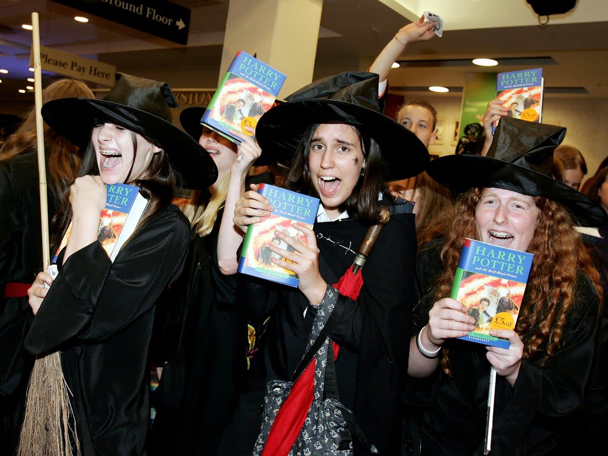 Harry Potter fans pick up fresh copies of ‘The Half-Blood Prince’ at a midnight opening in London in 2005 (Gareth Cattermole/Getty Images)