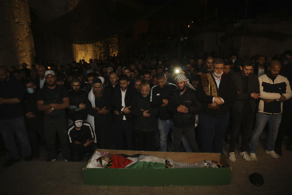 Muslim men pray next to the body of Iyad Halak after Israeli police shot him dead in Jerusalem's old city, Sunday, May 31, 2020. Israel's defense minister has apologized for the Israeli police's deadly shooting of an unarmed Palestinian man who was autistic. (AP Photo/Mahmoud Illean)