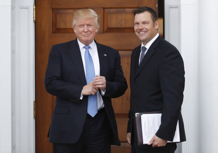 President-elect Donald Trump pauses pose for photographs as he greets Kansas Secretary of State, Kris Kobach, at the Trump National Golf Club Bedminster clubhouse, Sunday, Nov. 20, 2016, in Bedminster, N.J. (Photo: Carolyn Kaster/AP)