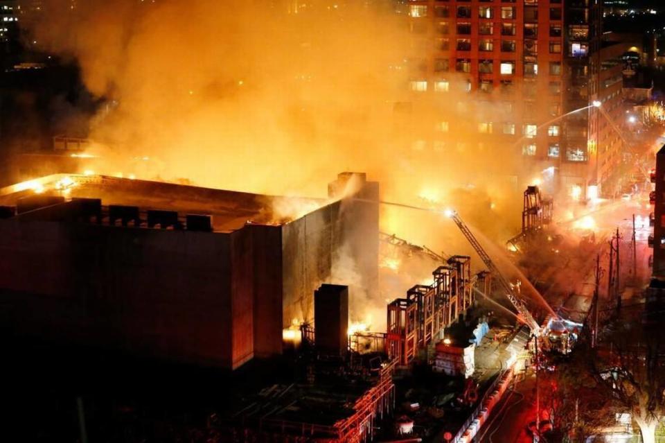 Firefighters on Harrington Street poured water on The Metropolitan, an apartment building under construction in downtown Raleigh that was destroyed by fire on March 16, 2017.