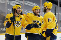 Nashville Predators defenseman Roman Josi (59) celebrates with Colton Sissons (10) and Mattias Ekholm (14) after Josi scored the winning goal against the Chicago Blackhawks in overtime of an NHL hockey game Tuesday, Jan. 26, 2021, in Nashville, Tenn. The Predators won 3-2. (AP Photo/Mark Humphrey)