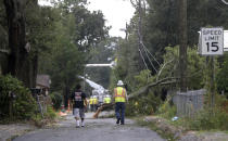 <p>Workers clear trees from power lines in Biloxi, Miss., in the aftermath of Hurricane Nate, Sunday, Oct. 8, 2017. (Photo: Gerald Herbert/AP) </p>