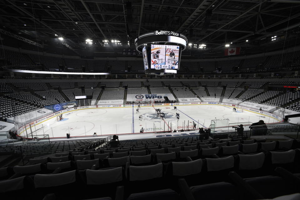 The puck is dropped during the first period of an NHL playoff game between the Edmonton Oilers and the Winnipeg Jets, in Winnipeg, Manitoba on Sunday, May 23, 2021. (Fred Greenslade/The Canadian Press via AP)