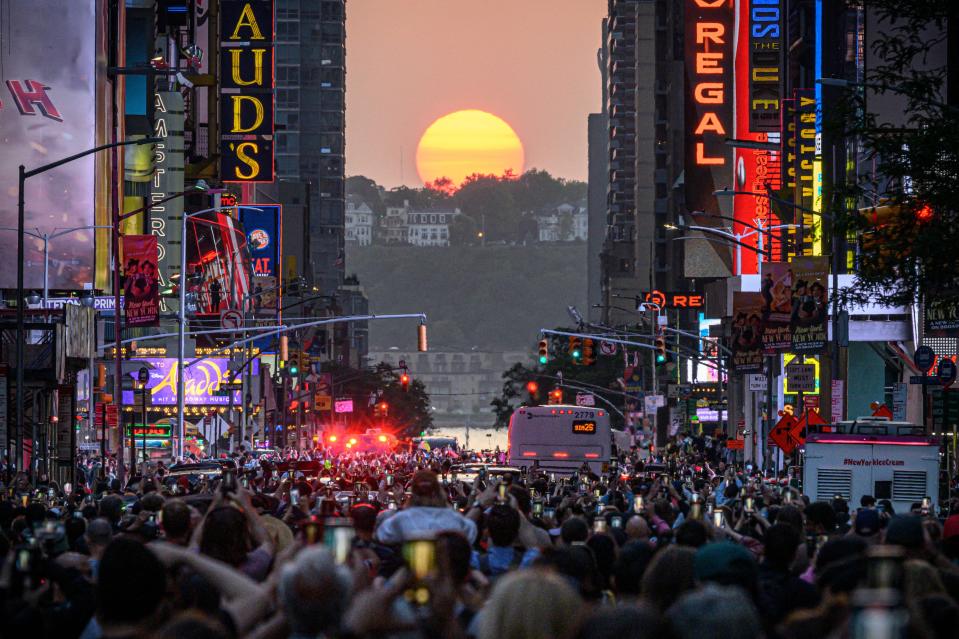 The sun sets in alignment with Manhattan streets running east-west, also known as Manhattanhenge, in New York City on May 30, 2023. Manhattanhenge occurs about the same two days in May and then again on two days in July every year.