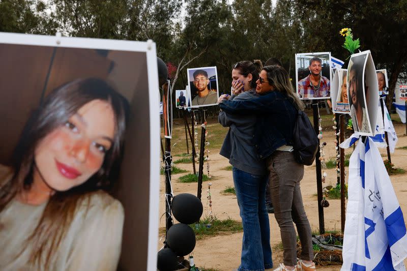 Family members and relatives visit the site of the Nova festival, in Reim