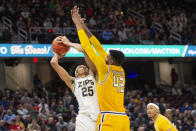 Akron's Enrique Freeman (25) attempts to shoot over Kent State's Cli'Ron Hornbeak (42) during the first half of an NCAA college basketball game in the championship of the Mid-American Conference tournament, Saturday, March 16, 2024, in Cleveland. (AP Photo/Phil Long)