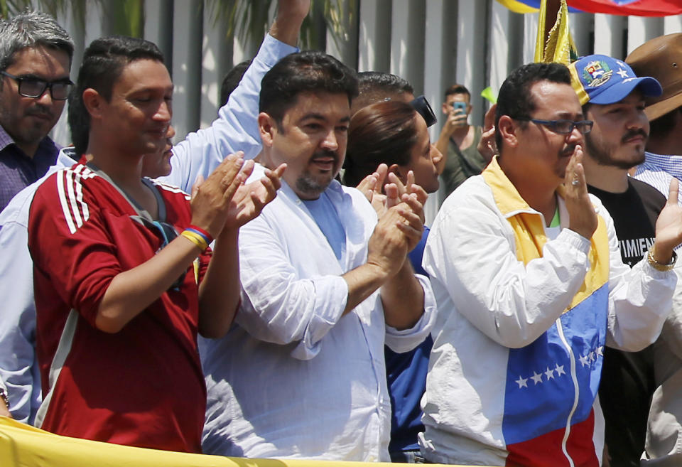 In this Saturday, March 16, 2019 photo, lawyer Roberto Marrero, center, applauds upon his arrival to a rally of Venezuelan opposition leader Juan Guaido, who has declared himself interim president in Valencia, Venezuela. Venezuelan security forces detained Marrero, a key aide to opposition leader Juan Guaido in a raid on his home early Thursday, March 21 an opposition lawmaker said. Marrero was taken by intelligence agents in the overnight operation in Caracas. (AP Photo/Fernando Llano)