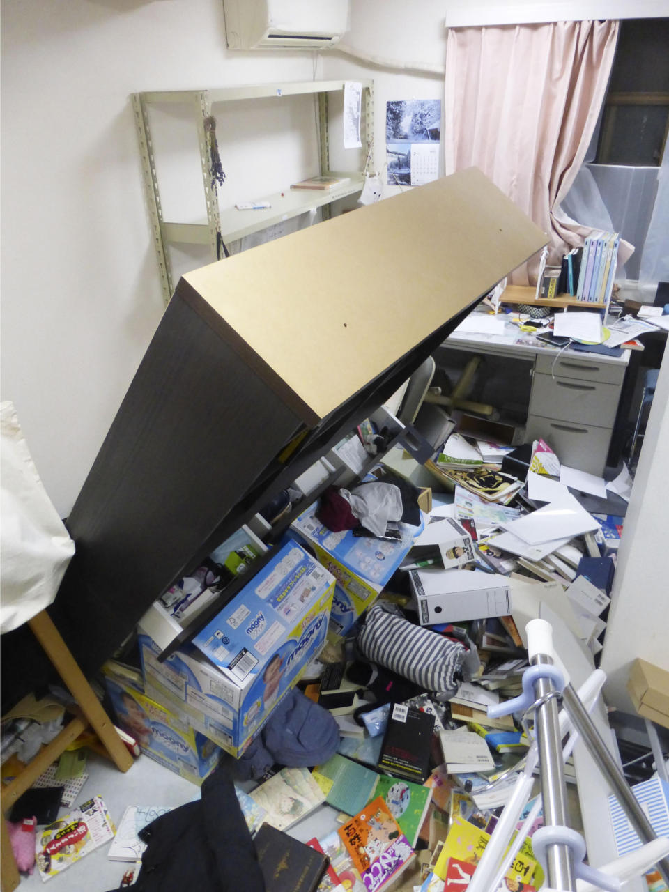 Furniture falls following an earthquake in Koriyama, Fukushima prefecture, northeastern Japan Saturday, Feb. 13, 2021. A strong earthquake hit off the coast of northeastern Japan late Saturday, shaking Fukushima, Miyagi and other areas, but there was no threat of a tsunami, officials said. (Kyodo News via AP)