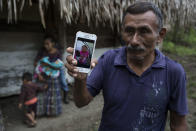 Domingo Caal Chub, 61, holds a smartphone displaying a photo of his granddaughter, Jakelin Amei Rosmery Caal Maquin, in Raxruha, Guatemala, on Saturday, Dec. 15, 2018. The 7-year-old girl died in a Texas hospital, two days after being taken into custody by border patrol agents in a remote stretch of New Mexico desert. (AP Photo/Oliver de Ros)