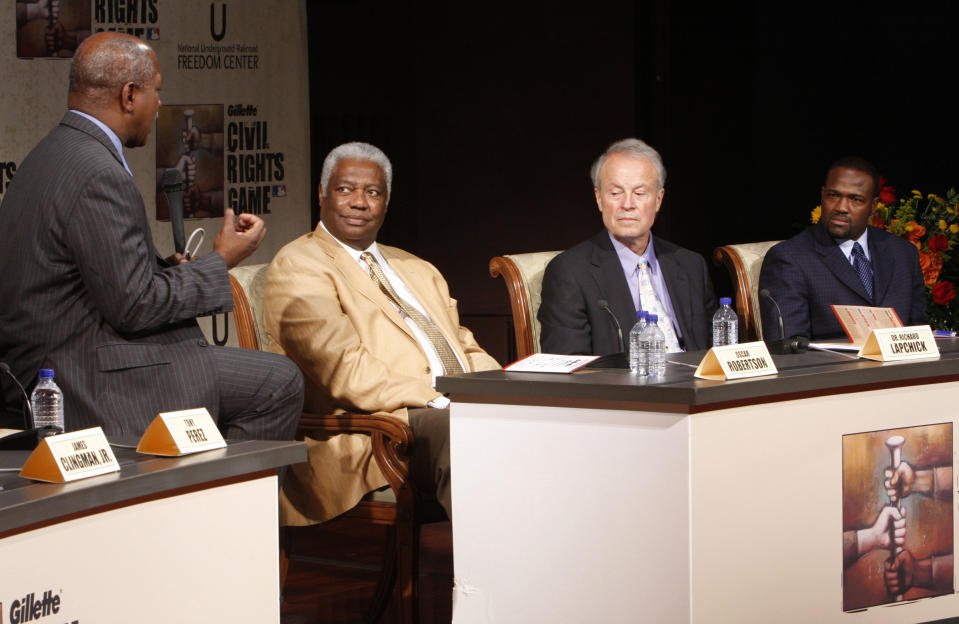 FILE - In this June 19, 2009, file photo, Moderator Charles Ogletree, from left, ask questions to a panelist including, basketball Hall of Famer Oscar Robertson, Dr. Richard Lapchick, director of the Institute for Diversity and Ethics in Sport and former MLB player Harold Reynolds as they discuss issues during the Civil Rights Game "Baseball and the Civil Rights Movement" discussion at the National Underground Freedom Center, in Cincinnati. Lapchick shares some of the backlash his family felt that was directed at his father for signing the first Black player to an NBA contract. (AP Photo/David Kohl, File)