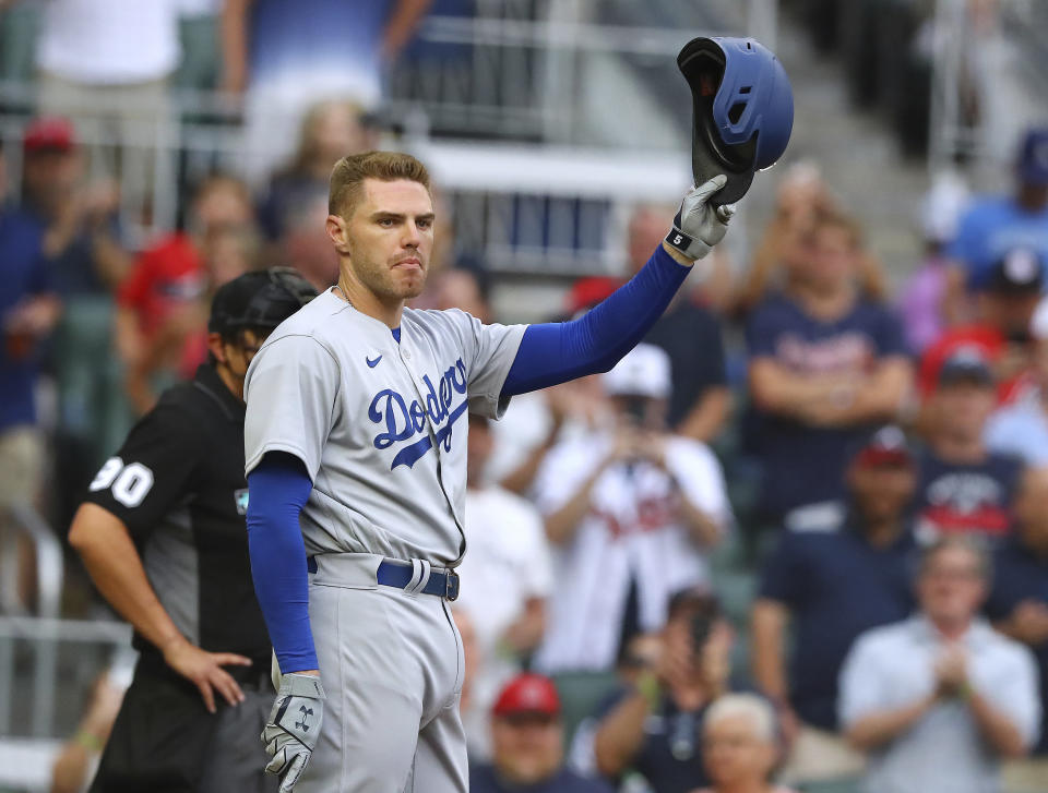 Former Atlanta Braves player Freddie Freeman tips his helmet to fans as he takes the plate to bat in the first inning, returning to Atlanta with the Los Angles Dodgers for a baseball game on Friday, June 24, 2022, in Atlanta. (Curtis Compton/Atlanta Journal-Constitution via AP)