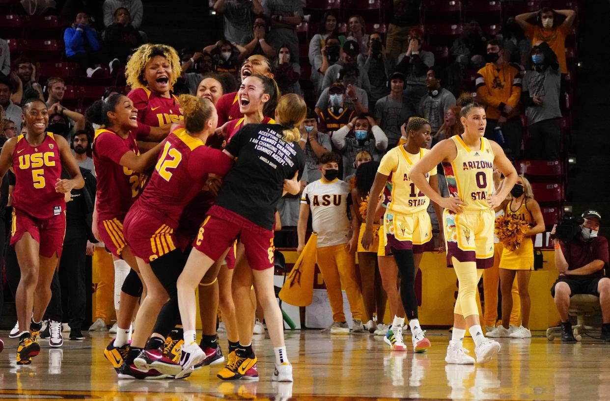Feb 24, 2022; Tempe, AZ, USA; USCÕs Alyson Miura (25) reacts with her teammates after hitting a game-winning three as time expires against ASU during a game at Desert Financial Arena. Mandatory Credit: Patrick Breen/The Republic