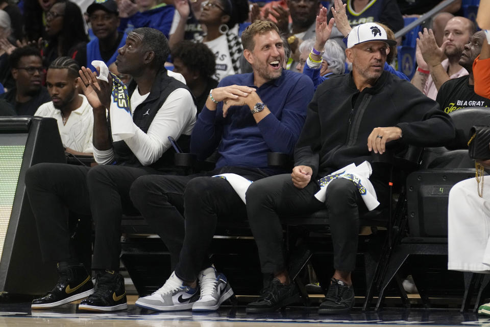 Former Dallas Mavericks players, Michael Finley, left, Dirk Nowitzki, center, and head coach Jason Kidd, right, watch the first half of Game 2 of a first-round WNBA basketball playoff series between the Atlanta Dream and Dallas Wings, Tuesday, Sept. 19, 2023, in Arlington, Texas. (AP Photo/Tony Gutierrez)