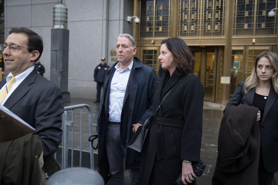 Charles McGonigal, center left, former special agent in charge of the FBI's counterintelligence division in New York, leaves court, Monday, Jan. 23, 2023, in New York. The former high-ranking FBI counterintelligence official has been indicted on charges he helped a Russian oligarch, in violation of U.S. sanctions. (AP Photo/John Minchillo)