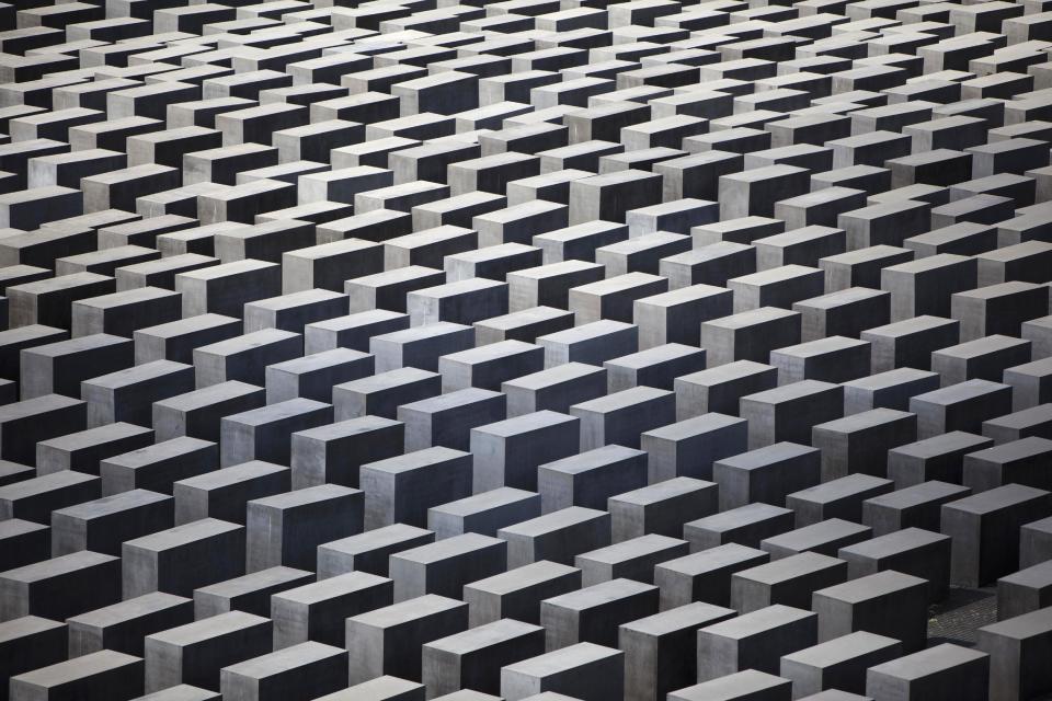 In this picture, taken June 17, 2011, the concrete slabs of the Holocaust Memorial in central Berlin are photographed . Berlin police say they are considering additional security for Germany’s main Holocaust memorial after an online video appeared to show New Year’s revelers urinated on the site last week. The YouTube video appears to show drunken partygoers relieving themselves and launching fireworks from among the 2,711 concrete blocks commemorating the 6 million Jews killed by the Nazis. The site in the heart of Berlin is close to the Brandenburg Gate where hundreds of thousands of people traditionally ring in the New Year. Police spokesman Thomas Neuendorf said Monday Jan. 6, 2014 that the site was specifically designed to be open to the public, but that a fence could be erected during big events. (AP Photo/Markus Schreiber,File)