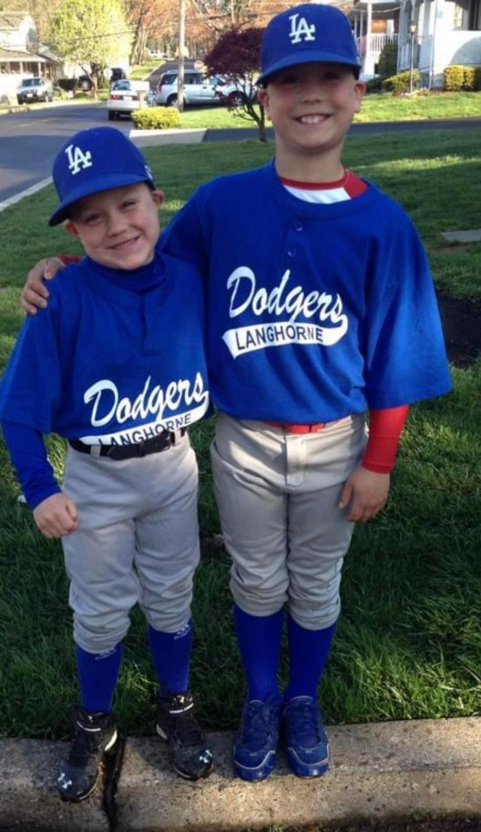 Five-year-old Chase Bonner, left, and 7-year-old brother Joel share a moment before playing a 2013 Langhorne Athletic Association game.